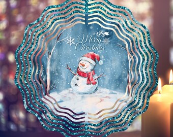 May include: A teal blue metal wind spinner with a winter scene featuring a snowman, trees, and snowflakes. The text "Merry Christmas" is printed on the spinner.