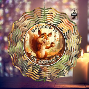 May include: A metal wind spinner with a colorful design of a squirrel holding an acorn in a forest setting. The text "Welcome to the Nuthouse" is printed on the spinner.