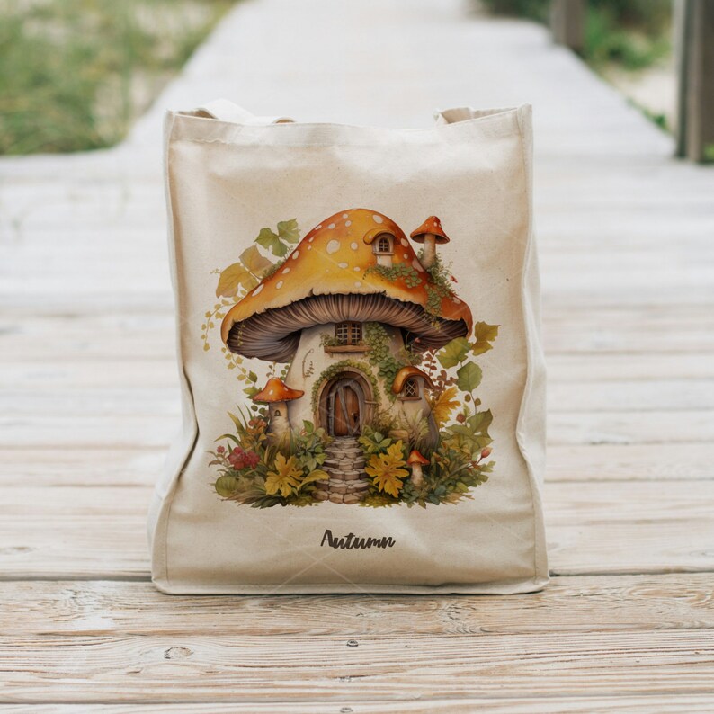 May include: A beige tote bag with a mushroom house illustration. The mushroom is orange and white with brown accents. The house has a door and windows. The bag has the word "Autumn" printed on the bottom.