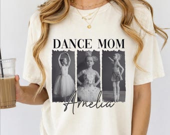 May include: Cream-colored t-shirt with the text "DANCE MOM" above three black and white photos of a young girl in ballet poses. The name "Amelia" is written in cursive below the photos.
