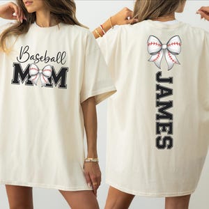 A woman wearing a white t-shirt with the text "Baseball Mom" and a baseball graphic, along with the name "James" printed on the back.