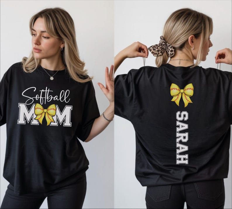 A woman wearing a black t-shirt with a white text design and a yellow bow on the back.