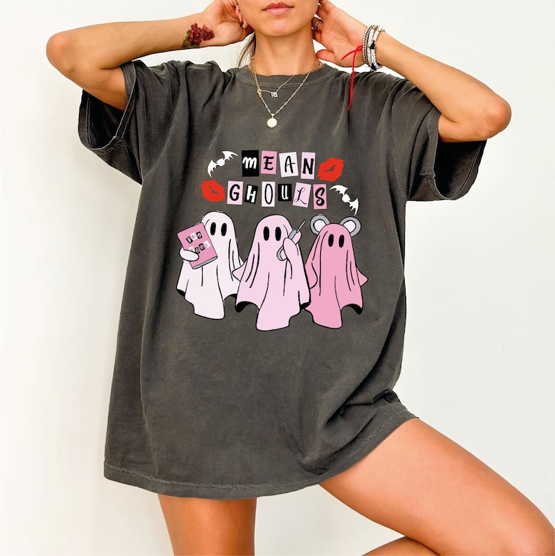 a woman wearing a t - shirt with a group of ghost on it