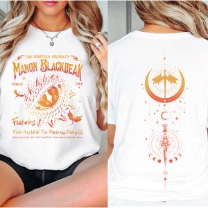 a woman wearing a white shirt with a design on it
