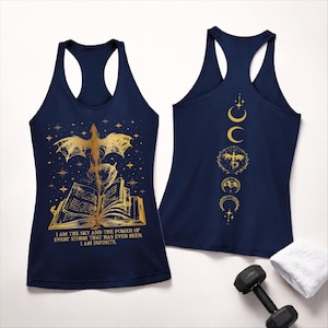 May include: Navy blue tank top with a gold dragon and book design. The front features a dragon over an open book with the text "I AM THE SKY AND THE POWER OF EVERY STORM THAT HAS EVER BEEN. I AM INFINITE." The back has a gold moon phase design.