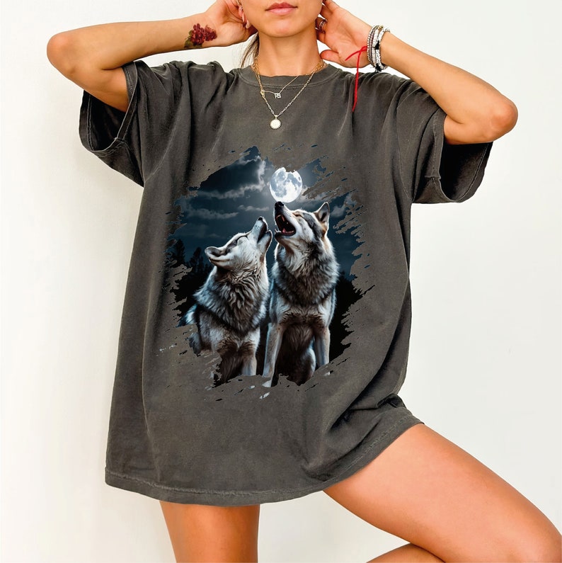 a woman wearing a t - shirt with two wolfs on it