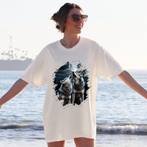 a woman standing on a beach next to the ocean