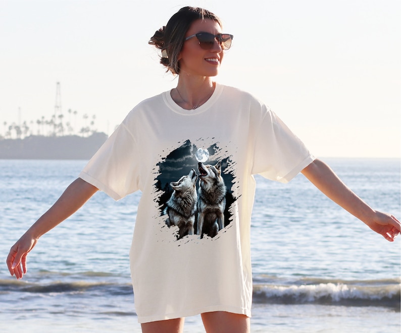 a woman standing on a beach next to the ocean