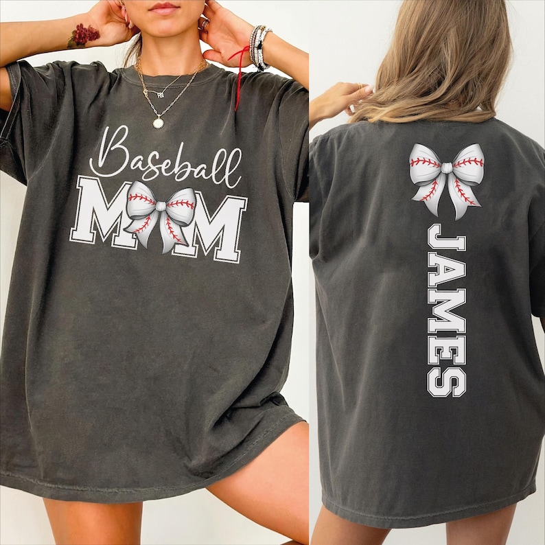 A woman wearing a gray t-shirt with the text "Baseball Mom" printed on it, along with a bow on the back.
