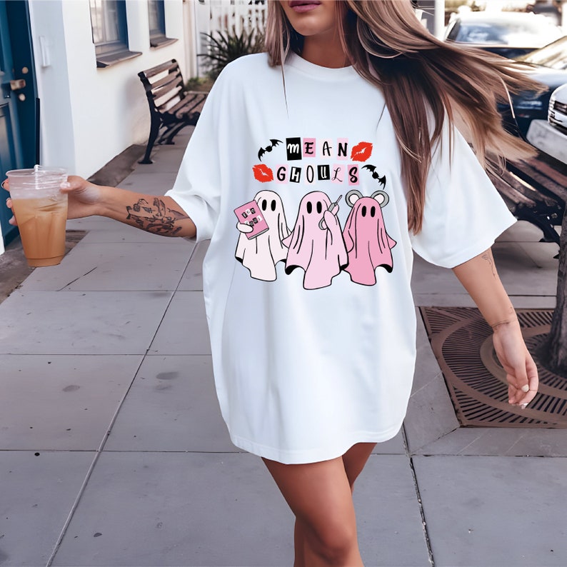 a woman walking down a sidewalk wearing a white shirt dress