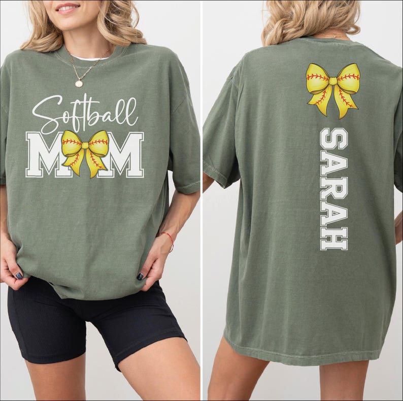 A woman wearing a green t-shirt with the text "Softball Mom" printed on it, along with a yellow bow.