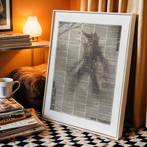 May include: A framed print of a black and white illustration from The Lord of the Rings: The Two Towers by J.R.R. Tolkien. The print is displayed on a black and white checkered surface.
