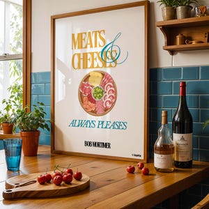 May include: A framed poster with the words "MEATS & CHEESE" and "ALWAYS PLEASES" above a graphic of a charcuterie board. A wooden table holds a cutting board with cherries, a blue glass, and two bottles of wine.