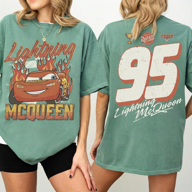 May include: Green t-shirt featuring Lightning McQueen from the Cars movie. The front graphic shows McQueen with flames and the text "Lightning McQueen" and "McQueen". The back has a large "95" and "Lightning McQueen" text.