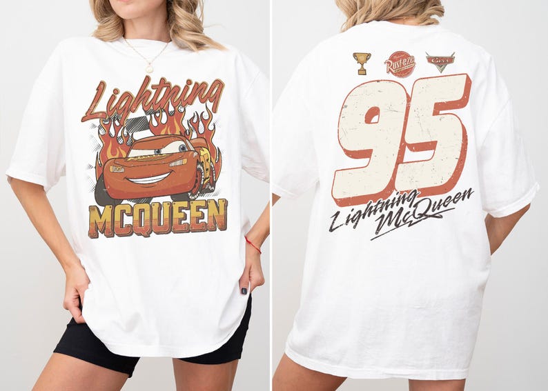 May include: White t-shirt featuring a distressed graphic of Lightning McQueen with flames and text. The back of the shirt displays the number 95, a trophy, and the text "Lightning McQueen".