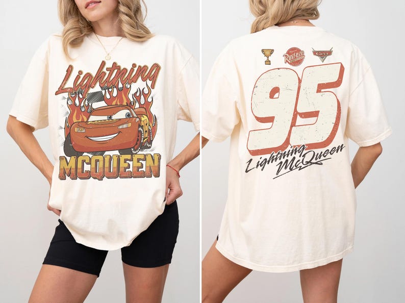 May include: Cream-colored t-shirt featuring Lightning McQueen from the Cars movie. The front graphic shows McQueen with flames and the text "Lightning McQueen". The back displays the number "95" and "Lightning McQueen".