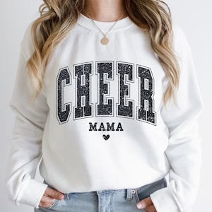 May include: White sweatshirt with black text that reads "CHEER MAMA" with a small black heart below the text.
