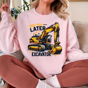 May include: Pink sweatshirt with a yellow excavator graphic and the text "See you later Excavator".