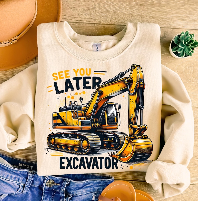 May include: A beige sweatshirt with a yellow excavator graphic and the text "See you later Excavator".