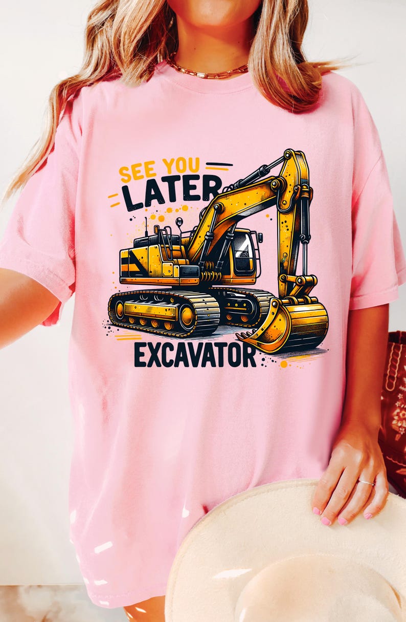 May include: Pink t-shirt with a yellow excavator graphic and the text "See You Later Excavator".