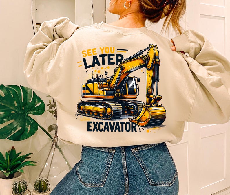 May include: A beige sweatshirt with a yellow excavator graphic and the text "See You Later Excavator".