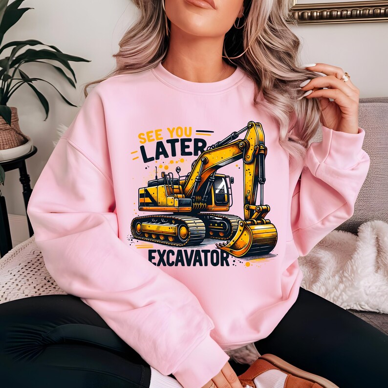 May include: Pink sweatshirt with a yellow excavator graphic and the text "See you later Excavator".