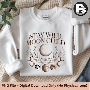 May include: White sweatshirt with the text "STAY WILD MOON CHILD" in a brown, decorative font. The design includes a crescent moon, phases of the moon, and floral elements. The sweatshirt is a digital download.