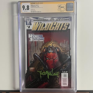 May include: A graded comic book featuring the Wildcats #v4 #1. The cover art depicts a red-masked character with a weapon, set against a red and black background. The comic is encased in a protective case and has a 9.8 grade.