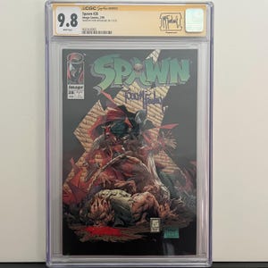 以下が含まれることがあります： ス ポーン #28 コミックブック、9.8 評価、ス ポーンと他のキャラクターの暗いイラストが特徴です。 カバーにはス ポーンのロゴとアーティストのサインがあります。 コミックは保護ケースに入っています。