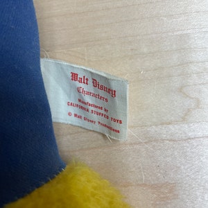 May include: A white tag with red text that reads "Walt Disney Characters Manufactured by California Stuffed Toys &copy; Walt Disney Productions".