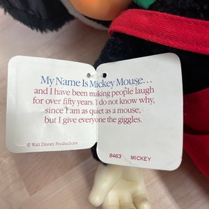 May include: A plush Mickey Mouse toy with a red and black outfit. The toy has a tag that reads "My Name Is Mickey Mouse... and I have been making people laugh for over fifty years. I do not know why, since I am as quiet as a mouse, but I give everyone the giggles."  &copy; Walt Disney Productions 8463 MICKEY
