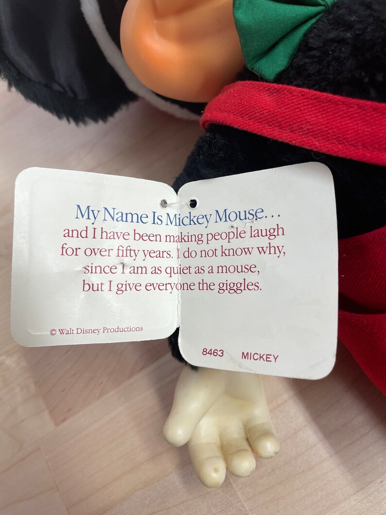May include: A plush Mickey Mouse toy with a red and black outfit. The toy has a tag that reads "My Name Is Mickey Mouse... and I have been making people laugh for over fifty years. I do not know why, since I am as quiet as a mouse, but I give everyone the giggles."  &copy; Walt Disney Productions 8463 MICKEY