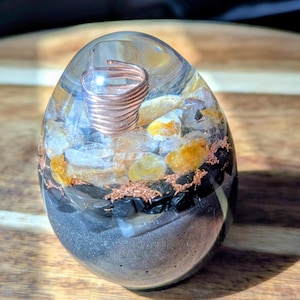 Huevo de orgonita sanador dorado.