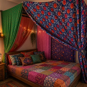 May include: A bed with a patchwork quilt featuring various colorful floral and geometric patterns. The bed is draped with a blue canopy patterned with orange circles and a green curtain. Several decorative pillows in matching colors are arranged.