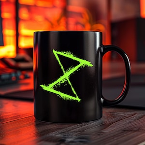 May include: Black coffee mug with a bright green symbol on the front. The symbol is a stylized X with a diagonal line through it.