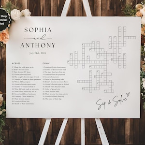 May include: A white wedding crossword puzzle sign with the names Sophia and Anthony and the date July 24th, 2024. The crossword puzzle has the words "Sip & Solve" at the bottom.