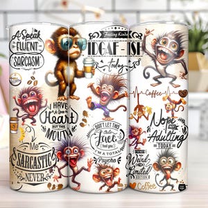 May include: White tumbler with a colorful design featuring monkeys, text, and coffee cups. The text includes phrases like "I have a good heart but this mouth", "Feeling Kinda IDGAF-ISH today", "Nope Not Adulting Today", and "Me Sarcastic Never".