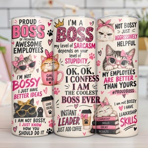 May include: A cylindrical tumbler featuring a cream background with pink and black text and illustrations of cats wearing bows and glasses. The text includes phrases like Proud Boss, I'm a Boss, and Not Bossy Just Aggressively Helpful, alongside coffee cups and books.
