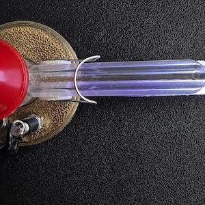 Macro of an illuminated acrylic arm tube showing the addressable LEDs inside