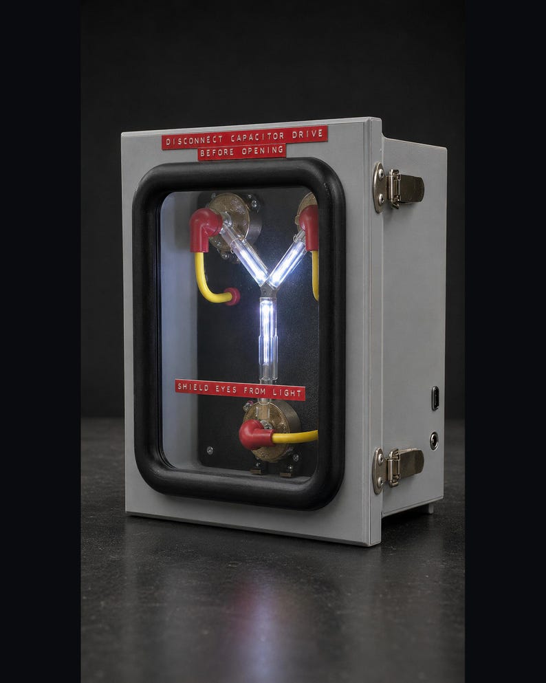 Flux Capacitor lit on a plain dark studio background, three-quarter view