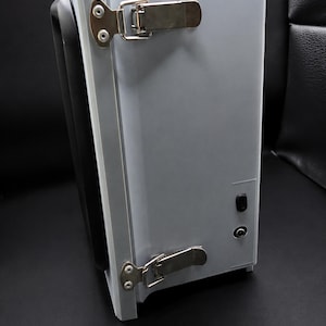 Side of the enclosure showing the twin latches and the USB-C and DC barrel power inputs