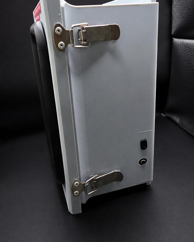 Side of the enclosure showing the twin latches and the USB-C and DC barrel power inputs