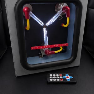 Flux Capacitor lit with the included 17-key infrared remote in front of it