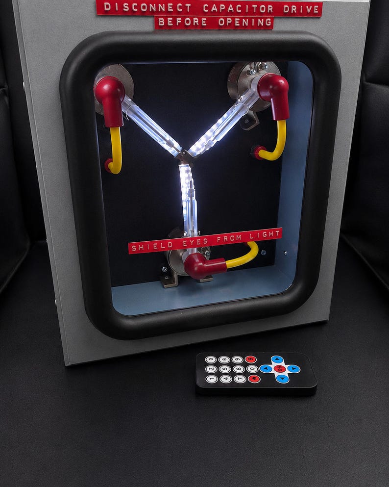 Flux Capacitor lit with the included 17-key infrared remote in front of it