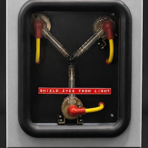 Flux Capacitor switched off showing the DISCONNECT CAPACITOR DRIVE and SHIELD EYES FROM LIGHT warning labels