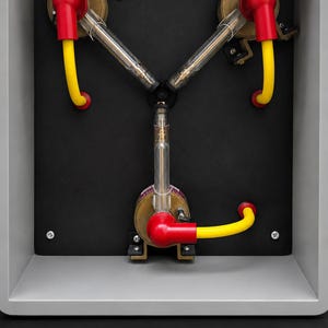 Back plate with the three hand-built arm assemblies, chrome bases, red boots and yellow leads