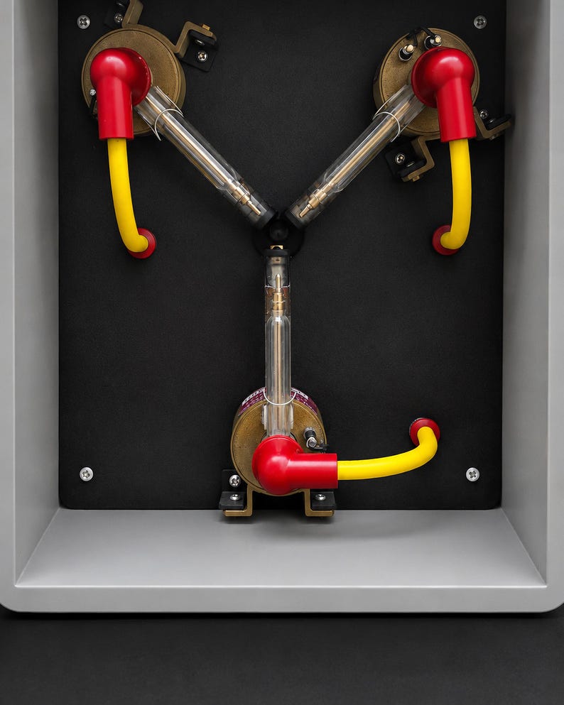 Back plate with the three hand-built arm assemblies, chrome bases, red boots and yellow leads