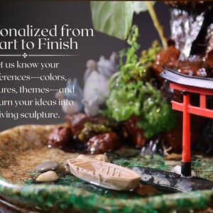 May include: A miniature zen garden with a waterfall, a red torii gate, and a small wooden boat. The garden is set in a ceramic dish with green moss and rocks. The text "Personalized from Start to Finish" is displayed above the garden.