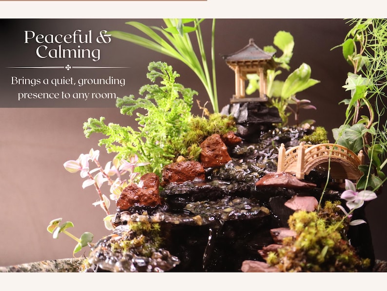 May include: A tabletop zen garden with a small waterfall, a bridge, and a miniature pagoda. The garden is decorated with moss, rocks, and small plants.