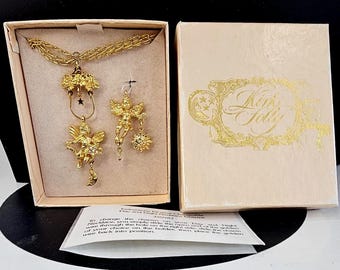 Collier vintage Kirks Folly Jour et Nuit avec breloques chérubins interchangeables et boîte d'origine J35983, couleur or, motif fées célestes
